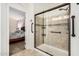 Glass-enclosed shower featuring attractive tile and a convenient grab bar at 42505 W Venture Rd, Maricopa, AZ 85138