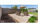Backyard featuring desert landscaping, a patio seating area, and an outdoor dining space at 5612 N 109Th Ave, Phoenix, AZ 85037