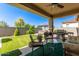 Enjoy this backyard featuring a covered patio, lush artificial turf, and outdoor seating at 5612 N 109Th Ave, Phoenix, AZ 85037