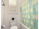 Functional bathroom with a toilet, bathtub, and a window with natural light at 5612 N 109Th Ave, Phoenix, AZ 85037