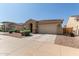 Single-story home with a red tile roof, desert landscaping, and an attached two-car garage at 5612 N 109Th Ave, Phoenix, AZ 85037