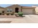 Single-story home with a red tile roof, desert landscaping, and an attached two-car garage at 5612 N 109Th Ave, Phoenix, AZ 85037