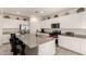 Bright kitchen featuring white cabinets, stainless steel appliances, and a granite island at 5612 N 109Th Ave, Phoenix, AZ 85037