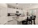 Bright kitchen featuring white cabinets, stainless steel appliances, and a granite island at 5612 N 109Th Ave, Phoenix, AZ 85037