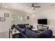 Inviting living room with large windows, white shutters, and a comfortable blue sectional at 5612 N 109Th Ave, Phoenix, AZ 85037