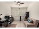 Bright office space with neutral colors, ceiling fan, comfortable futon, and practical desk setup at 5612 N 109Th Ave, Phoenix, AZ 85037
