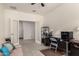Office features an open doorway, tiled floor, a desk area, and a comfortable sofa for relaxing at 5612 N 109Th Ave, Phoenix, AZ 85037