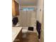 Functional bathroom featuring a shower-tub combo, wood-look flooring, and convenient storage cabinets at 5808 E Lockwood St, Mesa, AZ 85215