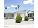 Inviting single-story home with a covered porch and well-manicured landscaping, offering a welcoming curb appeal at 5808 E Lockwood St, Mesa, AZ 85215