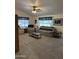 Spacious living room with neutral carpeting, comfortable seating, and a ceiling fan for added comfort at 5808 E Lockwood St, Mesa, AZ 85215