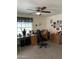 Home office space with wood cabinets and desk, with bright ceiling fan at 5808 E Lockwood St, Mesa, AZ 85215