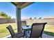 Relaxing outdoor patio with a table and chairs, perfect for enjoying the beautiful backyard and blue sky at 6319 W Hilton Ave, Phoenix, AZ 85043