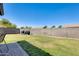 Large backyard with well-maintained lawn and secure fencing, perfect for outdoor activities at 6319 W Hilton Ave, Phoenix, AZ 85043