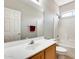 Bathroom featuring a white vanity, large mirror, bathtub, and a shower with a rainfall shower head at 6319 W Hilton Ave, Phoenix, AZ 85043