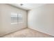 Carpeted bedroom with large window, neutral walls, and plenty of natural light at 6319 W Hilton Ave, Phoenix, AZ 85043