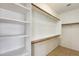 Walk-in closet with built-in shelving and wooden racks for optimal organization at 6319 W Hilton Ave, Phoenix, AZ 85043