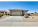 Single-story home with desert landscaping, two-car garage and concrete driveway at 6319 W Hilton Ave, Phoenix, AZ 85043
