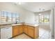 Open concept kitchen and eat-in area with lots of natural light from multiple windows at 6319 W Hilton Ave, Phoenix, AZ 85043