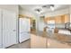 Spacious kitchen boasts an island with countertop, white appliances and wooden cabinets at 6319 W Hilton Ave, Phoenix, AZ 85043