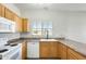 Bright kitchen features ample countertop space, wooden cabinets and white appliances at 6319 W Hilton Ave, Phoenix, AZ 85043