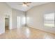 Spacious main bedroom with tile floors, vaulted ceiling, fan and ensuite bathroom at 6319 W Hilton Ave, Phoenix, AZ 85043