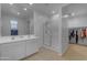 Well-lit bathroom featuring a double vanity and glass-enclosed shower with a walk-in closet at 7145 E Eagle Nest Way, San Tan Valley, AZ 85143