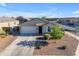 Charming single-Gathering home featuring a two-car garage, well-manicured landscaping, and a welcoming front entrance at 7145 E Eagle Nest Way, San Tan Valley, AZ 85143
