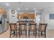 Well-lit kitchen featuring stainless steel appliances, modern cabinets, and a breakfast bar with comfortable seating at 7145 E Eagle Nest Way, San Tan Valley, AZ 85143