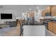 Open-concept kitchen with modern cabinetry, stainless steel appliances, and a breakfast bar overlooking the living area at 7145 E Eagle Nest Way, San Tan Valley, AZ 85143