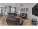 Comfortable living room with plush leather seating and contemporary ceiling fan at 7145 E Eagle Nest Way, San Tan Valley, AZ 85143