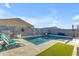 Sparkling pool featuring a Baja step and modern lounge chairs with a built in BBQ in the backyard at 7145 E Eagle Nest Way, San Tan Valley, AZ 85143