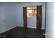 Cozy bedroom with wood-look flooring, a large window, and bright, colorful curtains at 717 E State Ave, Phoenix, AZ 85020