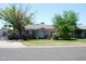 Charming single-story home featuring lush landscaping, a well-manicured lawn, and a welcoming front entrance at 717 E State Ave, Phoenix, AZ 85020