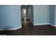 Hallway with hardwood floors and a view through an arched doorway at 717 E State Ave, Phoenix, AZ 85020