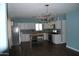 Modern kitchen featuring white cabinets, stainless steel appliances, dark countertops, and a stylish island at 717 E State Ave, Phoenix, AZ 85020