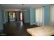 Open-concept living room featuring hardwood floors, a modern chandelier, and lots of natural light at 717 E State Ave, Phoenix, AZ 85020