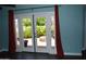 Living space with hardwood floors, French doors leading to a patio and colorful curtains at 717 E State Ave, Phoenix, AZ 85020