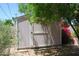 Exterior shot of backyard shed with a bougainvillea bush next to it at 717 E State Ave, Phoenix, AZ 85020