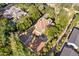 An aerial view features a stately home with lush greenery, a detached garage, and ample parking space at 7252 N Central Ave, Phoenix, AZ 85020