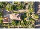 Overhead view showing lush greenery, a sparkling pool, and a well-maintained home with detached garage at 7252 N Central Ave, Phoenix, AZ 85020