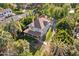 Aerial view of the house surrounded by lush greenery and mature palm trees at 7252 N Central Ave, Phoenix, AZ 85020