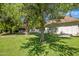 Expansive backyard with mature trees offering shade, a well-maintained lawn, and a charming home exterior at 7252 N Central Ave, Phoenix, AZ 85020