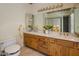 Bathroom featuring a dual sink vanity, and mirror, with a separate enclosed shower at 7252 N Central Ave, Phoenix, AZ 85020