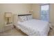 Inviting bedroom with a comfortable bed, side table, and lamp with a window view at 7252 N Central Ave, Phoenix, AZ 85020