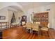 Spacious dining room with hardwood floors, a large wood table, and a decorative bookcase at 7252 N Central Ave, Phoenix, AZ 85020
