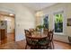 Charming dining room with wood floors, a round table, and a view into the adjacent kitchen at 7252 N Central Ave, Phoenix, AZ 85020