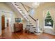 Grand foyer featuring a staircase, hardwood floors, and classic chandelier at 7252 N Central Ave, Phoenix, AZ 85020