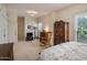 Spacious main bedroom featuring a comfortable bed, and a rocking chair at 7252 N Central Ave, Phoenix, AZ 85020