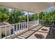 Exterior porch view with hanging plants, trees, a white railing, and a gazebo at 7252 N Central Ave, Phoenix, AZ 85020