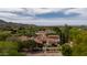 Breathtaking aerial view highlighting the estate's beautiful terracotta roof, lush greenery, and mountain views at 7525 N Shadow Mountain Rd, Paradise Valley, AZ 85253
